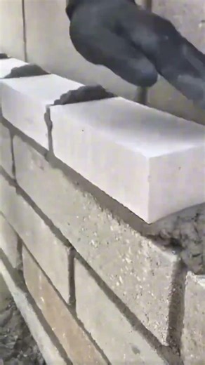 Lay the lightweight concrete blocks tightly along the entire length of the wall #construction