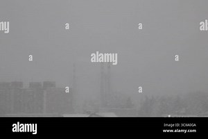 View from the window of a house during a heavy snowfall.