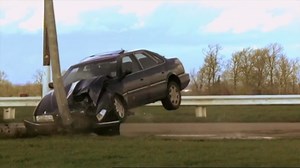 What happens when a car hits a road sign head-on at full speed