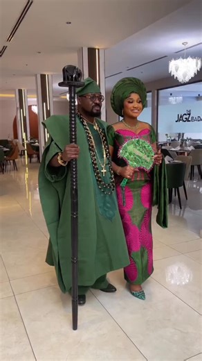 Oprah’s cut on Instagram: "Bride Lola’s traditional wedding look featured a green and pink Asooke skirt and blouse ensemble, thoughtfully styled to complement her husband. The skirt’s embroidered details paired seamlessly with soft pink accents on the blouse, creating a refined look that highlighted their unity and elegance as a couple. Outfit designed by @oprahs_cut Bride @dr_lola.t Planner @hot_event Makeup @oteniaramakeovers Gele @t_best_gele Fan: @onyix_craft #oprahscut #nigerianbride #bella