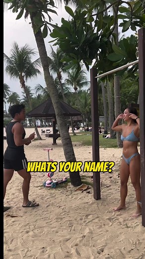 Woman in Bikini Doing Pull Ups at Sentosa Beach in Singapore
