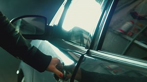 A woman opens and enters the car - Free Stock Video