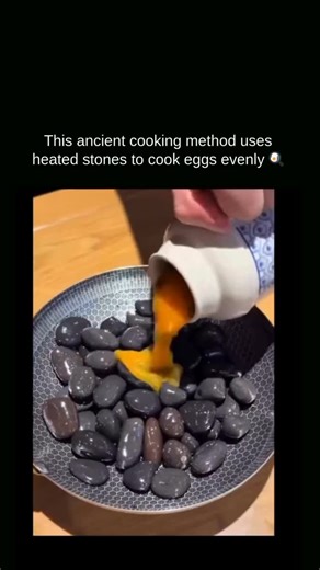 Curio Dose on Instagram: "Cooking eggs in hot fried gravel relies entirely on heat transfer, without using a pan or oil. The gravel is heated over an open flame until it reaches very high temperatures, storing thermal energy across thousands of tiny stones. When an egg is buried in the hot gravel, heat is conducted evenly from all sides, cooking it without any direct contact with fire. The shell acts as a protective barrier, preventing scorching while the intense, surrounding heat quickly sets t