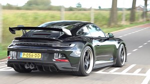 Porsche 911 GT3 RS driving away on a straight road