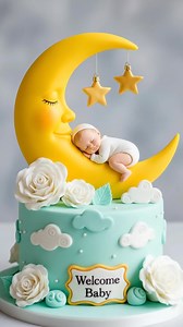 “Moonlight Baby Shower Cake🎂👶🌙.” It’s a whimsical single-tier design perfect for baby showers or newborn celebrations, featuring pink and white swirls, golden stars, and a sculpted crescent moon cradling a sleeping baby, wrapped in glowing lights. #cake #cakedecorating #baking #gifts #Christmas | Rechartcake