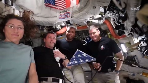 Artemis II astronauts show off Apollo 18 flag from space
