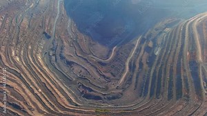 Open pit mining for steel production. A giant iron ore quarry. Aerial view of an open pit quarry