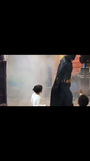 Child's Playful Batman Costume Adventure at Fiesta