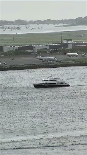 Motorboat cruises through the harbor with a visible wake, with the #Shorts