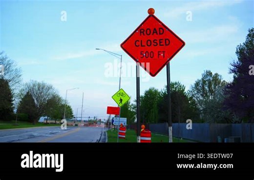 Road closed sign with orange warning color on street. Traffic restriction and construction safety sign. High quality 4k footage Stock Video Footage - Alamy