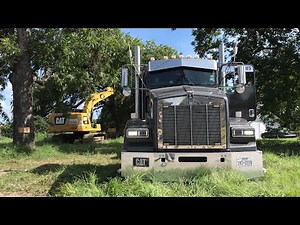 Kenworth hauling excavator in the county roads of TEXAS