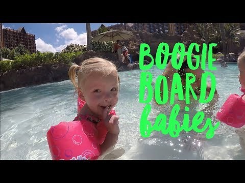 QUADRUPLETS BOOGIE BOARD IN THE OCEAN