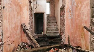 Destruction: ruin of abandoned and demolished building after a cataclysm. Bare walls of derelict old house due to hurricane, earthquake or tsunami damage.