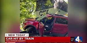 Car with woman inside hit by train