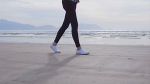 clip-13834721-slow-motion-video-woman-walking-on-wet