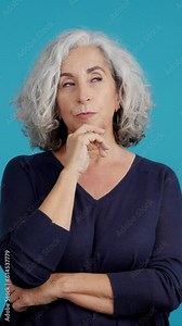 Mature woman looking up with an expression of discontent