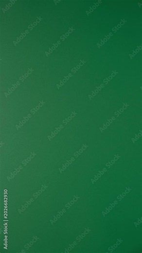 Stop motion animation of crumpled paper on a green background