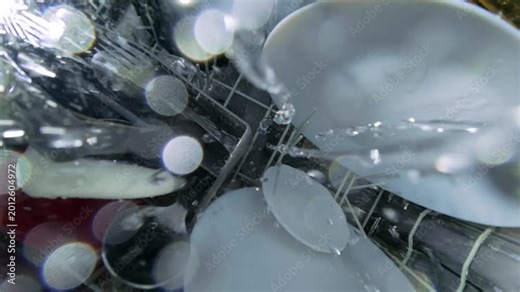 Top Down View from Rotating Arm Inside Dishwasher with Water Spray