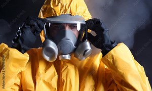 Intense Close-Up of Hazmat Suit Professional Adjusting Respirator Mask: Essential Footage for Biohazard Safety, Environmental Protection, Pandemic Response, and Industrial Hazard Training Videos