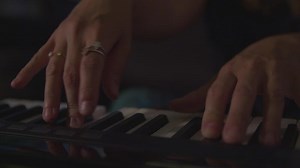 Slow motion of woman playing keyboard