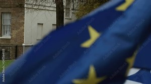 BREXIT - Close-up shot the EU and UK flags in front of Brexiteer red poster which reads We Voted Leave, in London, UK Stock Video