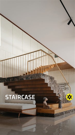 Buildofy on Instagram: "The staircase in Villa Shakti is conceived as a striking architectural feature that bridges functionality and sculpture. Rising dramatically from the plinth, it begins in contrasting marble and gradually transitions to wood and steel as it ascends, symbolizing movement and lightness. Positioned near the central pool court, it visually connects both levels of the home while maintaining openness and flow. Its material contrast and elegant geometry make it a defining element