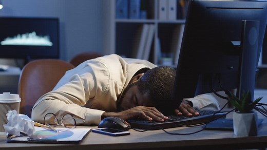 Office Worker Sleeping On The Table In Front Of The Computer In The Office At Night | Free Stock Video Footage