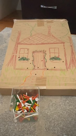 HOMEMADE HAMMER TOY! Simple cardboard box is turned into a fun hammer game with drawings of a house. This has been lots of fun with our young friends this week. I’m using golf tees and a hammer to build strength and bilateral coordination. Holding the box up in a vertical position also gave us an opportunity to kneel and work on shoulder strength to hammer. Love this simple activity! Great way to give those boxes a second life before recycling. #toddlerplay #preschoolplay #occupationaltherapy #t