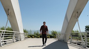 Premium stock video - Walking across bridge