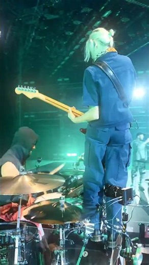 Emily on top of Colin's drums playing her guitar, Up From The Botton #linkinpark