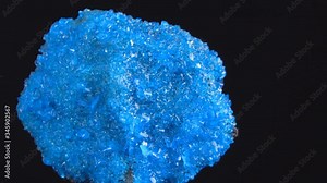Blue Covelline or Covellite Crystals slowly rotates on a black background. Copper sulfide (CuS), from Etna volcano. Mineral of volcanic origin