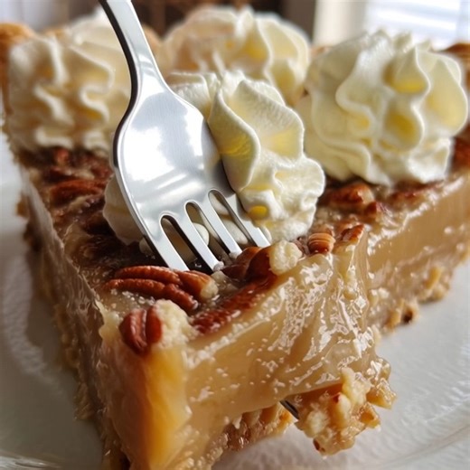 This is Dolly Parton's famous Butterscotch Pie, and it's a true Southern delight. It starts with a unique, chewy pecan-meringue crust that's unlike anything you've had before. Inside, a light, fluffy, and incredibly creamy no-bake butterscotch filling melts in your mouth. Piled high with whipped cream, it's a simple, decadent, and unforgettable dessert that's perfect for sharing. #DollyParton #ButterscotchPie #PieRecipe #NoBakeDessert #SouthernDessert #ComfortFood #DessertGoals #PecanPie #Butter
