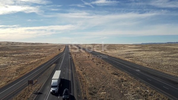 Large semi truck hauling freight on the open highway in the western...