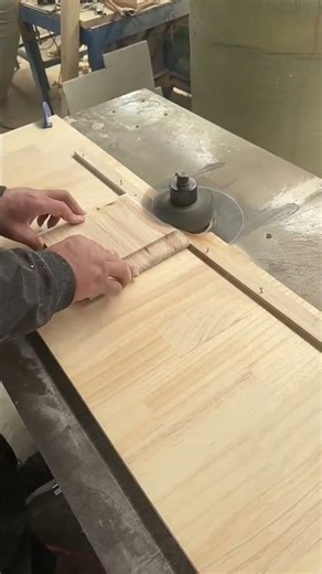 Professional carpenter using industrial shaper machine to cut wood edges
