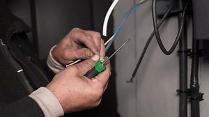Electrician installs wiring using Connectors for connecting wires in automation and electronics equipment. Connection of electrical wires of electrical appliances