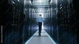 Server Engineer in Data Center Walks Through Sliding Doors and Opens Server Rack Cabinet. Shot on RED EPIC-W 8K Helium Cinema Camera.