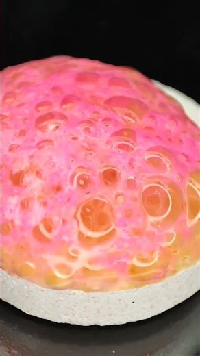 Effervescent Tablet Dissolves Into Pink and Black Transformation