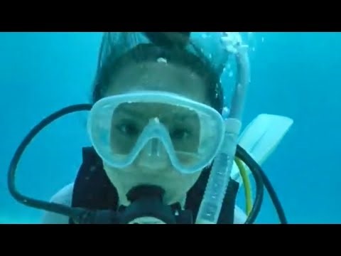 Female Diver is Diving with TUSA Neoprene Wetsuit