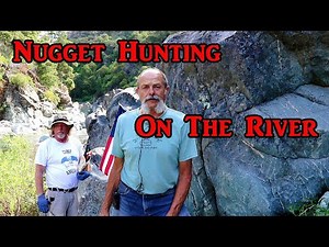 Panning and detecting on the river for gold.