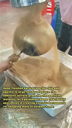 Artisan Applying Gold Glitter To Giant Christmas Ball Ornament