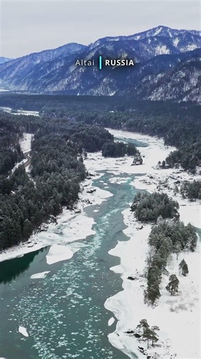 Aerial cinematic view of snow covered beautiful Altai
