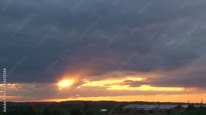 Quick summer sunset over the forest and farm/Sunset and clouds over the forest and farm in the summer. On the horizon the chimney's smoke. Clouds of blue and red. Time lapse.