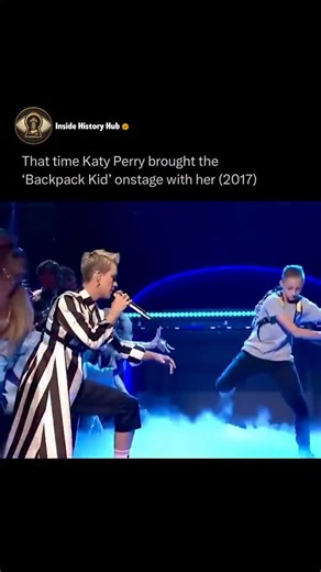 Inside History Hub on Instagram: "🎤😭🤣 Katy Perry performed Swish Swish with viral Backpack Kid on Saturday Night Live 2017. Russell Horning's signature Floss dance stole the show. Follow @insidehistoryhub for more 😂 The unexpected collab mixed pop energy and internet meme magic. Iconic moment still cracks people up years later."