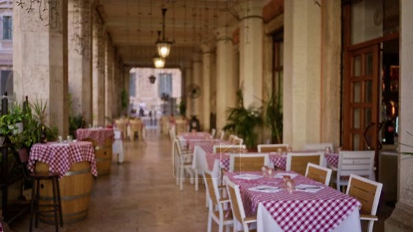 Blurred cafe terrace with soft bokeh, out of focus checkered tables and stone columns in an outdoor arcade; background backplate copyspace Stock Video Footage - Alamy