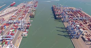 Aerial Time lapse - Commercial port with container ship during loading and unloading