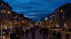 Time lapse of city traffic. A crowd of people and a lot of cars moving in the evening street. Wenceslas Street. Prague, Czech Republic. 4K