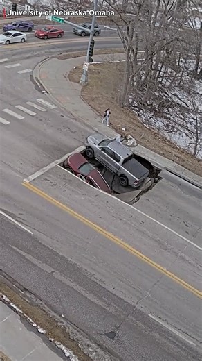 WHOA: Video shows the moment a sinkhole swallowed two vehicles at an intersection in Omaha, Nebraska. | Region 8 News