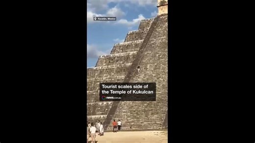 Tourist scales side of the Temple of Kukulcan
