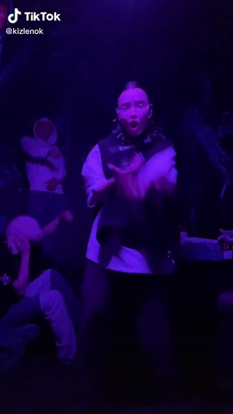 Dynamic Dance Moves in a Colorful Club Setting