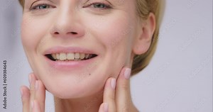 Woman touching face, beauty and skin with smile, antiaging cosmetic treatment and clean skincare. Natural cosmetics, happy female model and facial with portrait, dermatology and wellness with glow